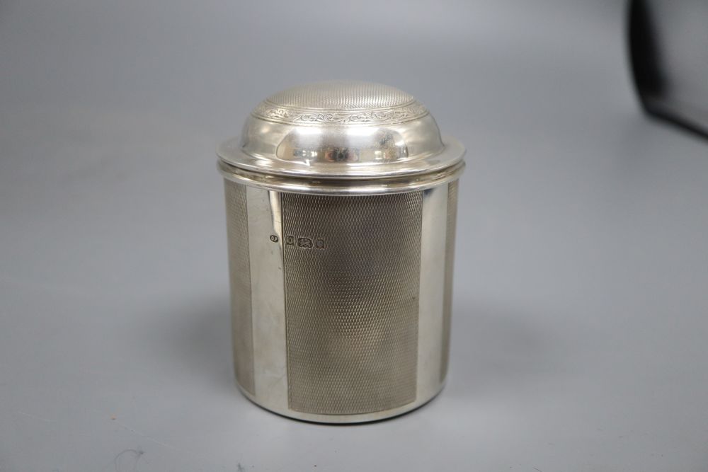 A 1920s engine turned cylindrical cigarette dispenser, London, 1929, 9.5cm, 8oz.